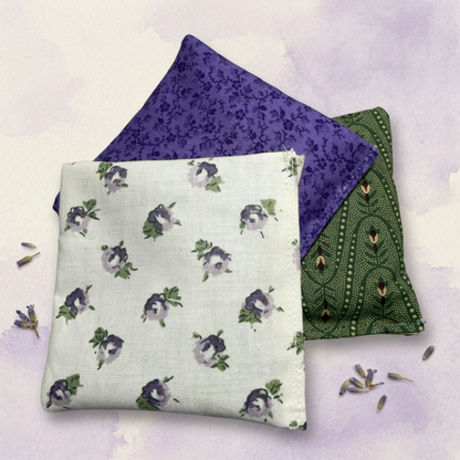 Three lavender sachets with different patterns on a light purple background