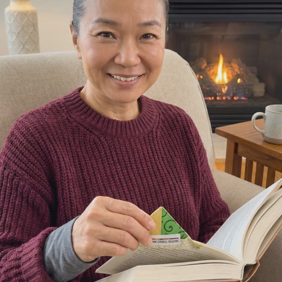 Woman advertising usage of corner bookmark