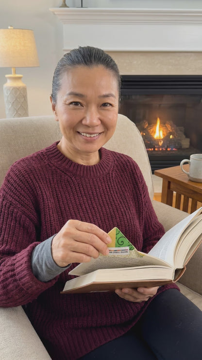 Woman advertising usage of corner bookmark